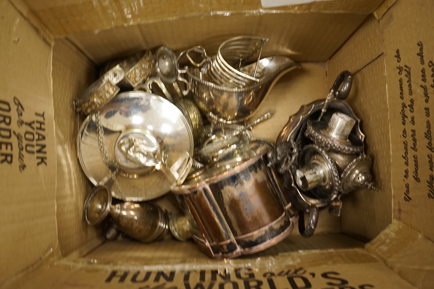 A quantity of assorted plated wares, including flatware, a tea caddy, a chatelaine, a toast rack, a sauceboat, a butter dish and a pair of candlesticks, etc.